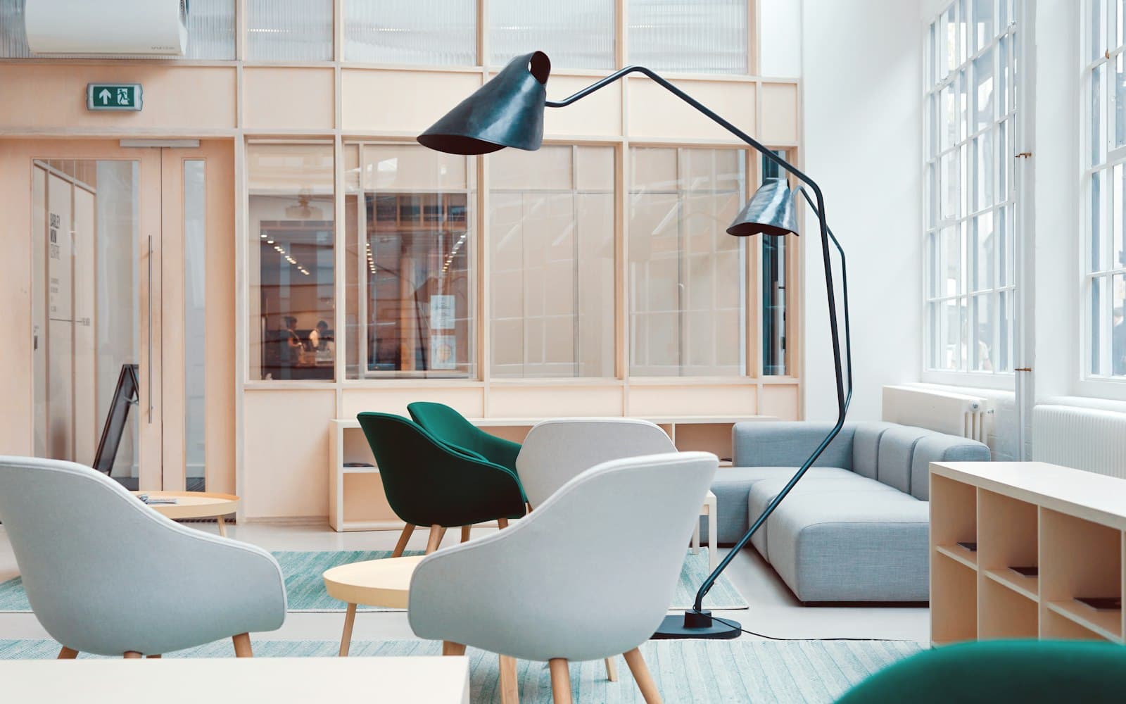 Lounge seating and an arc floor lamp in a light-filled workspace